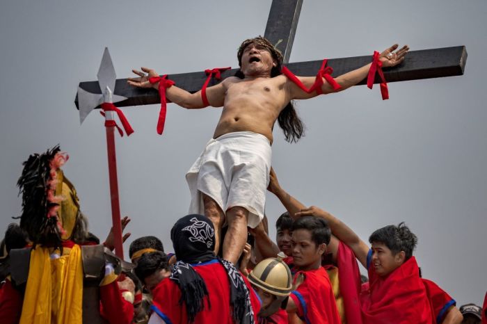 Penitent Ruben Enaje grimaces in pain as he is nailed to a cross during Good Friday crucifixions on April 07, 2023 in San Fernando, Pampanga, Philippines. 