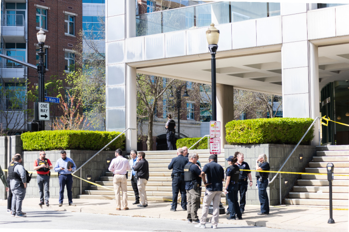Investigators stand around the area where a shooting occurred in downtown Louisville, Kentucky, on April 10, 2023, leaving five dead, including the gunman, and eight hospitalized. 