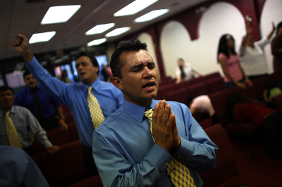 Louis Enrique, originally from Nicaragua, prays during a service in a store front church August 9, 2007, in the Little Havana neighborhood of Miami, Florida. 