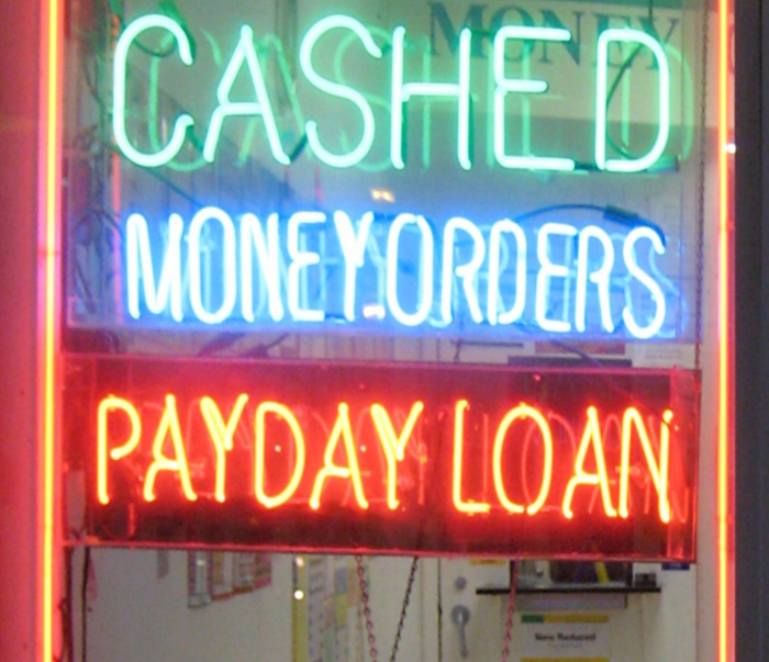A shop window in Falls Church, Va., advertises payday loans.
