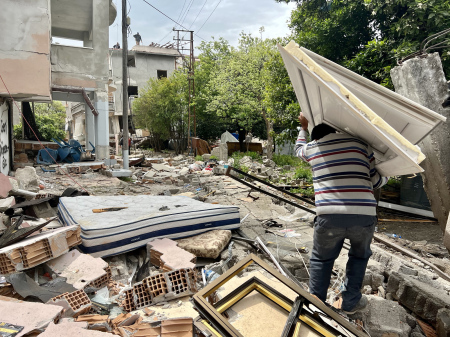 A man hauls debris amid the wreckage caused by an earthquake that struck Antakya, Turkey, in February 2023.