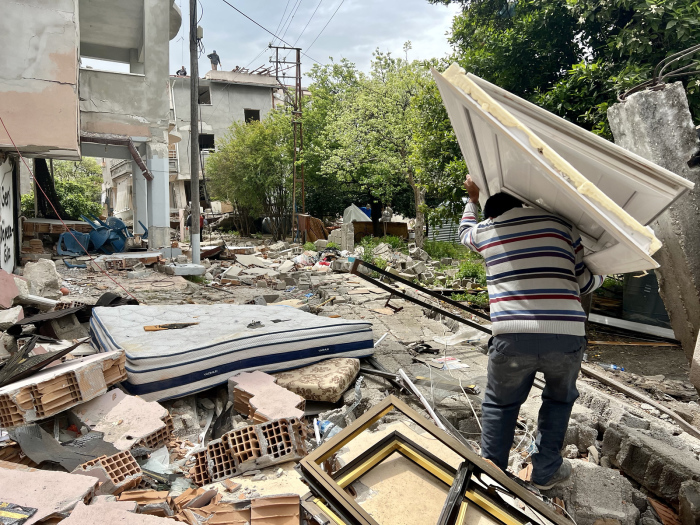 A man hauls debris amid the wreckage caused by an earthquake that struck Antakya, Turkey, in February 2023. 