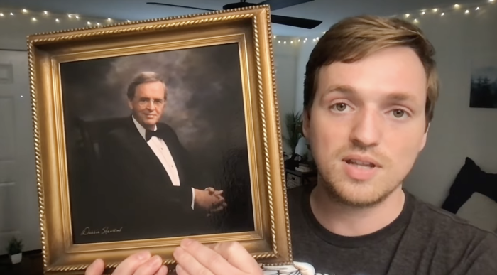 Matt Brodersen holds a framed photo of his grandfather, the late Charles Stanley, on April 25, 2022. 