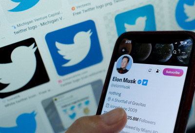 This illustration photo taken in Los Angeles on April 20, 2023, shows Elon Musk's blue tick next to his name on a smartphone.