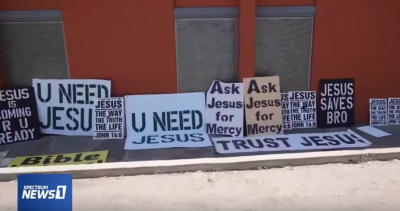A screenshot of a video showing signs taken down by the 'Atheist Street Pirates.'