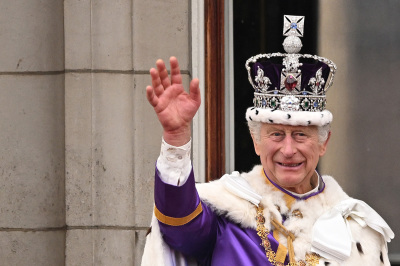 Britain's King Charles III wearing the Imperial state Crown, waves from the Buckingham Palace balcony after viewing the Royal Air Force fly-past in central London on May 6, 2023, after his coronation. - The set-piece coronation is the first in Britain in 70 years, and only the second in history to be televised. Charles will be the 40th reigning monarch to be crowned at the central London church since King William I in 1066.