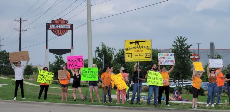 Protesters gathered Sunday outside Cottonwood Creek Church ahead of a community prayer vigil. 