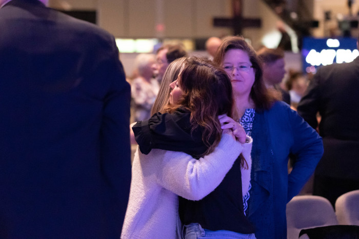 Members of the Allen community comfort one another during a prayer vigil at Cottonwood Creek Church.