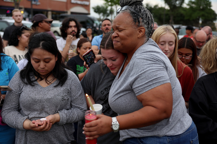 Tara Williams (R) hugs Marley Hall during a vigil at a memorial next to the Allen Premium Outlets on May 7, 2023, in Allen, Texas. The memorial is for the victims of the mass shooting in the Allen Premium Outlets mall on May 6. According to reports, a shooter opened fire at the outlet mall, killing eight people. The gunman was then killed by an Allen Police officer that was responding to an unrelated call. 