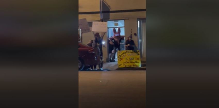 A screenshot of a video from outside a drag show at a North Texas church as a person in a "furry" costume stands in the doorway.
