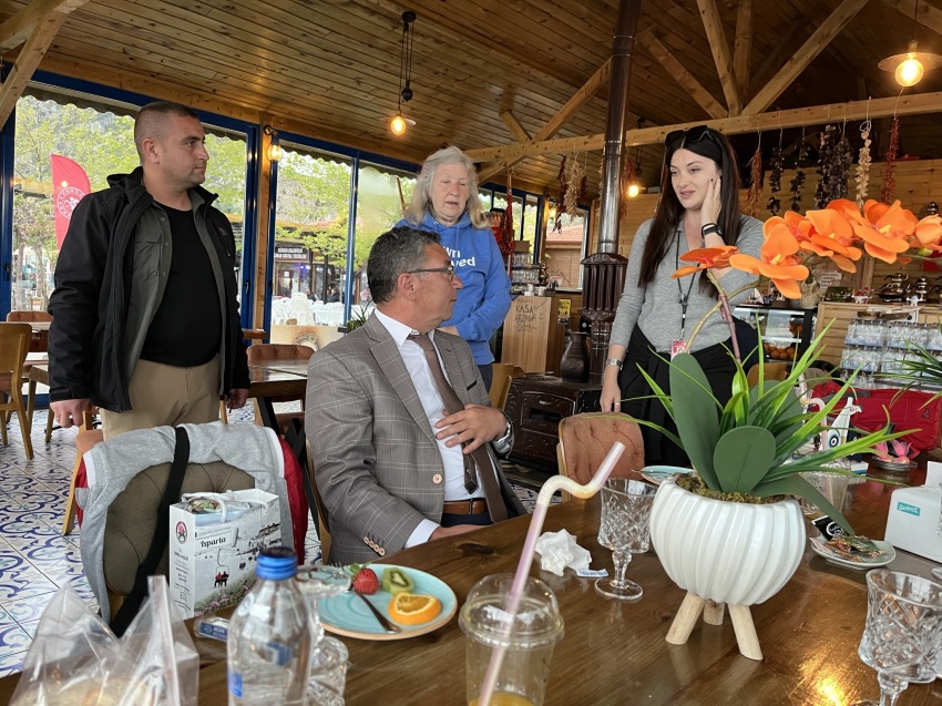 Mayor Veli Gok (seated) of Egirdir, Turkey, talks about his town with journalists and officials from Turkey's Ministry of Tourism at the Arzava Restaurant.