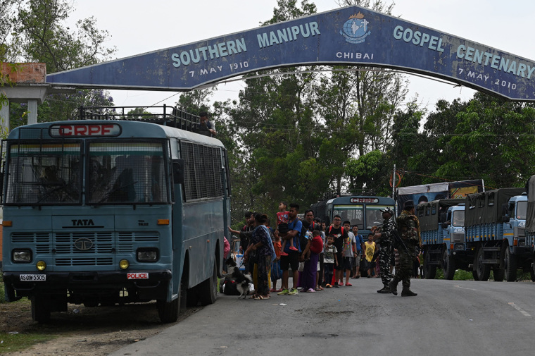 Meitei refugees queue along to board a paramilitary truck at a transit point after being evacuated from the violence that hit Churachandpur, near Imphal in the northeastern Indian state of Manipur on May 9, 2023. More than 70 people, mostly Christians, have been killed in the hilly border region in clashes between the majority Meitei people, who are mostly Hindus, and the mainly Christian Kuki tribe. Thousands of troops have been deployed to restore order, while around 23,000 residents have fled their homes for the safety of ad-hoc army-run camps for the displaced. 
