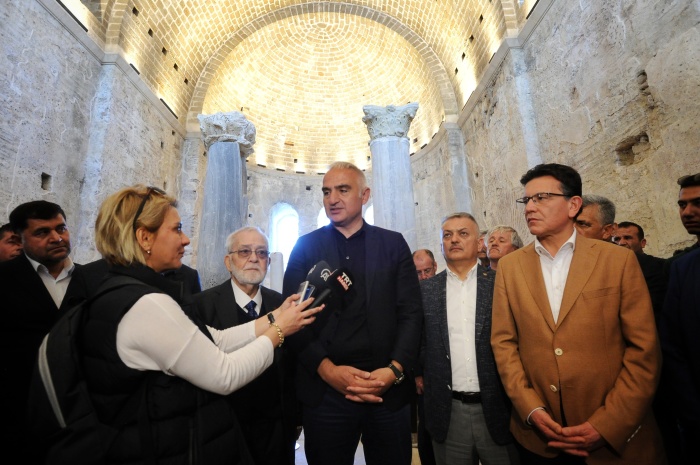 Turkey's Minister of Culture and Tourism Mehmet Nuri Ersoy (C) at the official reopening of the renowned St. Nicholas Church in Antalya in May 2023.