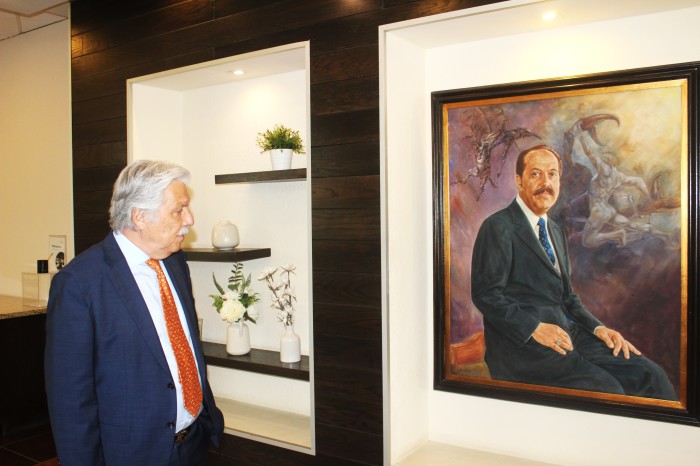 Dr. Francisco Contreras, director, president and chairman of the Oasis of Hope Hospital in Tijuana, Mexico, looks at a painting of his father, Dr. Ernesto Contreras Sr., who founded the alternative cancer clinic in 1963 with his wife.