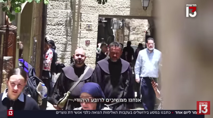 An Israeli journalist (right) disguised as a priest walks with a priest in Jerusalem.