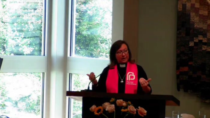 Female PCUSA pastor Rebecca Todd Peters wore a pink stole emblazoned with the Planned Parenthood logo during her sermon July 9. 