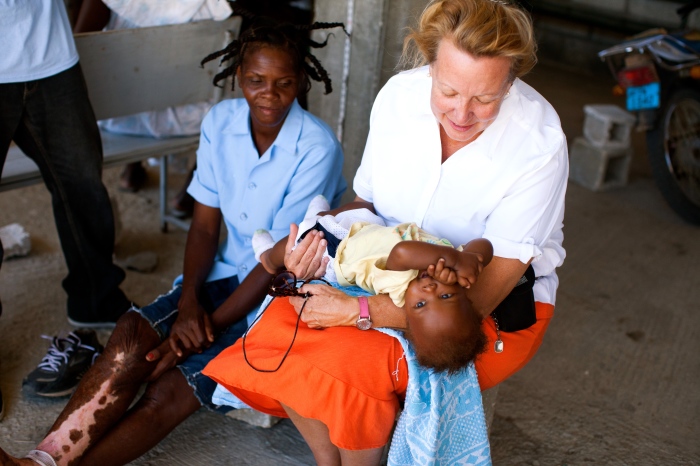 LiveBeyond co-founder and missionary Laurie Vanderpool with a mother and her child at the ministry's hospital in Thomazeau, Haiti.