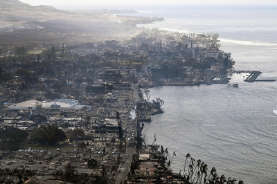 An aerial image taken on August 10, 2023, shows destroyed homes, buildings and the harbor area burned to the ground in Lahaina in the aftermath of wildfires in western Maui, Hawaii. At least 53 people have died after a fast-moving wildfire turned Lahaina to ashes, officials said August 9, as visitors asked to leave the island of Maui found themselves stranded at the airport. The fires began burning early August 8, scorching thousands of acres and putting homes, businesses and 35,000 lives at risk on Maui, the Hawaii Emergency Management Agency said in a statement. 