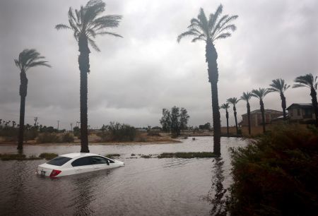 A car is partially submerged in floodwaters as Tropical Storm Hilary moves through the area on August 20, 2023 in Cathedral City, California. Southern California is under a first-ever tropical storm warning as Hilary impacts parts of California, Arizona and Nevada. All California state beaches have been closed in San Diego and Orange counties in preparation for the impacts from the storm which was downgraded from hurricane status.