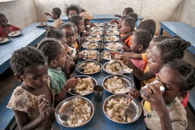 Schoolchildren from Ankileisoke Primary School eat lunch, offered by the World Food Programme's Under-nutrition Prevention Programme, in the Amboasary-South district of southern Madagascar, on December 14, 2018. In addition to ensuring that children can eat at least once a day, this program also ensures that children come to school. At the southern tip of Madagascar, the noise and excitement of the country's election campaign seems far away as locals confront more pressing needs in a daily struggle for food. For several seasons now, the entire southern part of Madagascar has been caught up in a drought that has made water increasingly scarce, wrecking even efforts to grow rice - the staple food.