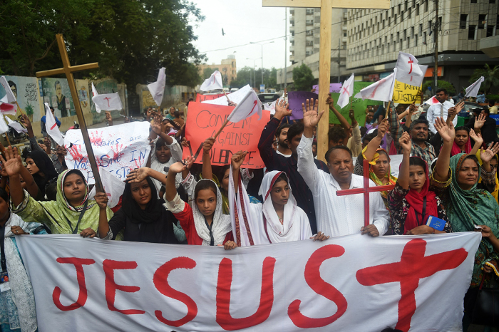 Christians hold the holy cross as they shout slogans during a protest in Karachi on August 26, 2023, to condemn the attack on churches in Pakistan. More than 80 Christian homes and 19 churches were vandalised in an hours-long riot in Jaranwala in Punjab province on August 16, after allegations that a Koran had been desecrated spread through the city. 