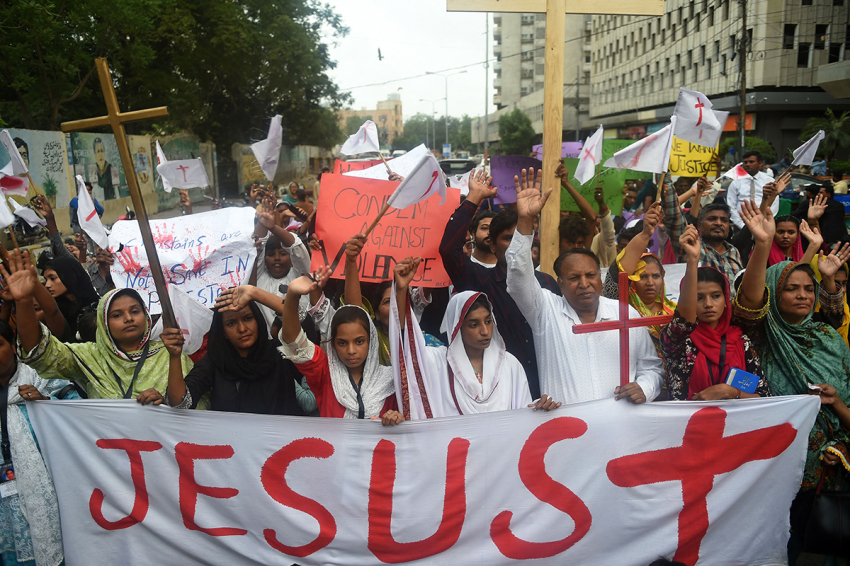 Christians hold the holy cross as they shout slogans during a protest in Karachi on August 26, 2023, to condemn the attack on churches in Pakistan. More than 80 Christian homes and 19 churches were vandalised in an hours-long riot in Jaranwala in Punjab province on August 16, after allegations that a Koran had been desecrated spread through the city.