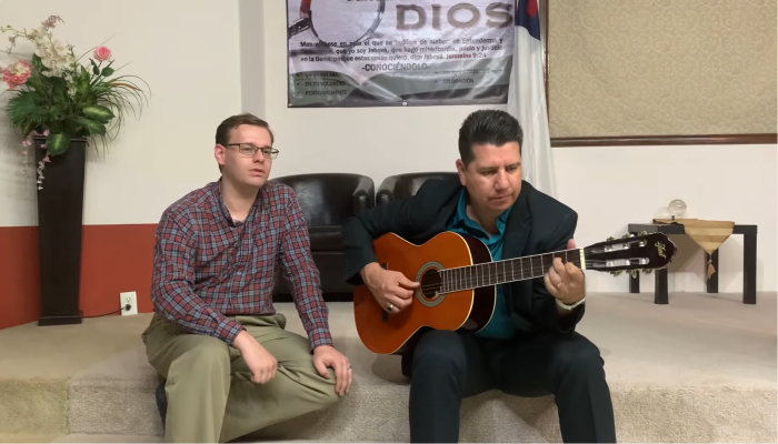 Traveling pastor, Benjamin Garlick (L), 32, sings at a Spanish-speaking ministry.