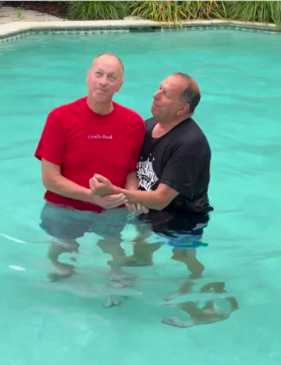 Former Buffalo Bills quarterback Jim Kelly (L) prepares to be dunked into the water during a baptism recorded and posted to Instagram on Sept. 21, 2023. 