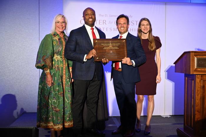 Sen. Tim Scott (R-S.C.) (center-left) receives the 2023 Distinguished Christian Statesman Award given by the D. James Kennedy Center for Christian Statesmanship from Jennifer Kennedy Cassidy (left), Chairman of the Board of D. James Kennedy Ministries and daughter of Dr. D. James Kennedy; Dr. Rob Pacienza (center right), Senior Pastor of Coral Ridge Presbyterian Church and President and CEO of D. James Kennedy Ministries; and Lauren Cooley (right), Executive Director of the D. James Kennedy Center for Christian Statesmanship.