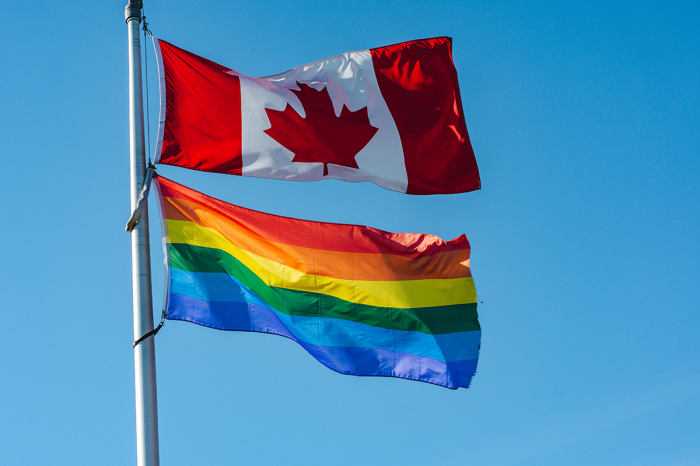 Rainbow flag flying together with Canadian flag in London, Ontario, Canada
