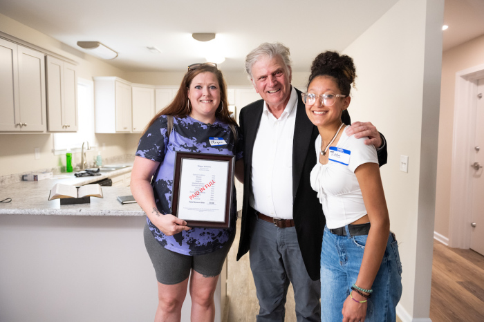 Megan Williams (left) stands in her new home, joined by Franklin Graham, the President and CEO of Samaritan's Purse. Following the December 2021 tornado that hit Mayfield, Kentucky, Williams and her family lost their home. They were gifted a new home in September 2023. 