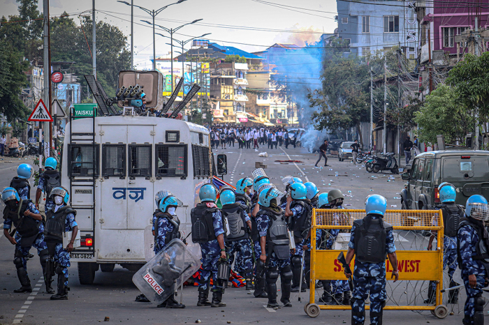 Security personnel fire tear gas as students protest against the killing of two missing students and to demand peace in India's northeastern state of Manipur amid ongoing ethnic violence, in Imphal on September 27, 2023. 