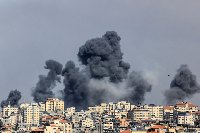 Smoke rises over Gaza City on October 7, 2023, during Israeli airstrikes. Palestinian militants have begun a 'war' against Israel, the country's defense minister said on October 7 after a barrage of rockets were fired and fighters from the Palestinian enclave infiltrated Israel, a major escalation in the Israeli-Palestinian conflict. 
