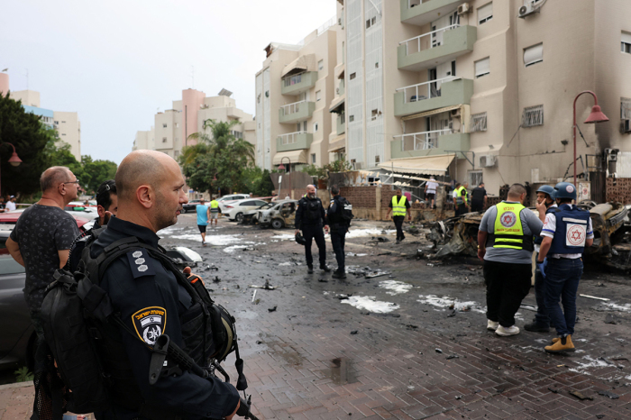 Israeli emergency responders inspect the site of a rocket attack in the southern Israeli city of Ashdod on October 9, 2023. Israel relentlessly pounded the Gaza Strip early Monday as fighting raged with Hamas around the Gaza Strip and the death toll from the war surged above 1,100. 