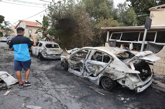 A man inspects the damage in the southern Israeli city of Ashkelon after a rocket attack from Gaza on October 9, 2023. Israel relentlessly pounded the Gaza Strip overnight and into October 9 as fighting with Hamas continued around the Gaza Strip, as the death toll from the war against the Palestinian militants surged above 1,100. 