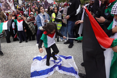 A child stomps on an Israeli flag during a demonstration in Chicago, Illinois, to show support for the Palestinian people on October 11, 2023. Rally marshals stopped the display and attempted to take the flag. Organizers of the event called on the U.S. government to stop supporting Israel, which they refer to as a 'racist, apartheid state.' 
