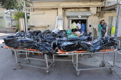 Bodies of people killed in the attack by Gaza-based Hamas militants on southern Israel await identification outside the National Center for Forensic Medicine in Tel Aviv on October 16, 2023. 