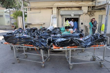 Bodies of people killed in the attack by Gaza-based Hamas militants on southern Israel await identification outside the National Center for Forensic Medicine in Tel Aviv on October 16, 2023.