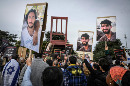 Supporters of Israel, members of the Jewish community and hostages' families and friend attend a rally calling for the release of hostages held by Hamas, next to a chair sculpture titled the 