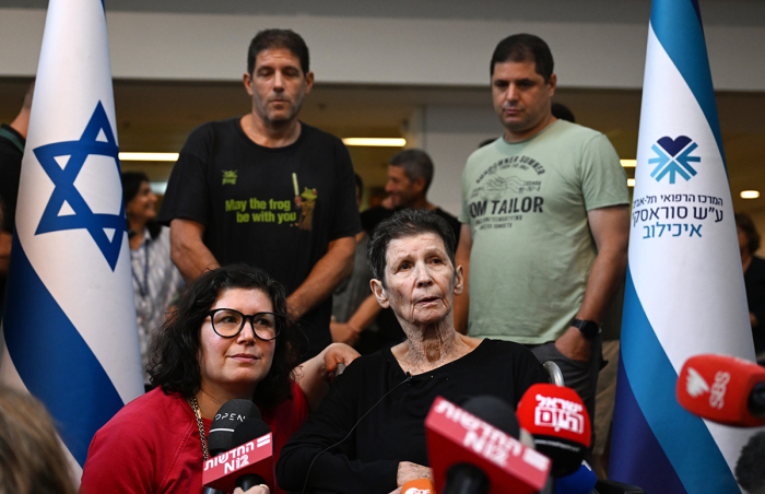 Yocheved Lifshitz (C) speaks to the media alongside her daughter, Sharone Lifschitz, (L) outside Ichilov Hospital after she was released by Hamas last night, on October 24, 2023, in Tel Aviv, Israel. Last night, two hostages taken by Hamas on October 7, Nurit Cooper and Yocheved Lifshitz, were released to the Red Cross within Gaza and returned to Israel. This followed the release of two other hostages, both U.S. nationals, who were released on Saturday. 
