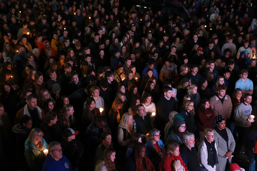 An overflow crowd watches a television screen as it broadcasts from inside the Basilica of Saints Peter and Paul the remembrance ceremony on October 29, 2023, in Lewiston, Maine. The ceremony was held to remember those killed and injured when Robert Card opened fire, killing 18 people in two separate locations on October 25, 2023.
