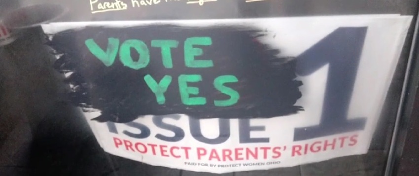 A sign in opposition to Ohio's Issue 1, which would make abortion access a state constitutional right, which was placed in the door of an Archdiocese of Cincinnati property and later vandalized in October 2023.