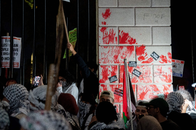 Demonstrators leave red hand prints on the fence in front of the White House during a rally in support of Palestinians in Washington, D.C., on November 4, 2023. 