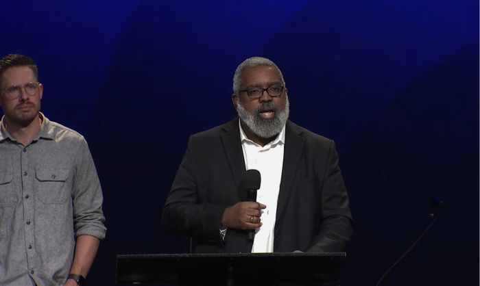 Stuart Greaves (podium), executive director of IHOPKC provides an update on the investigation of founder Mike Bickle at the Forerunner Church on Sunday, Oct. 5, 2023. Forerunner Church lead pastor, Isaac Bennett (L) looks on.