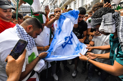 Demonstrators prepare to burn a make-shift Israeli flag during a demonstration in Algiers on October 19, 2023, after Hamas invaded Israel and murdered over 1,400 people and captured over 240 people who are being held as hostages in Gaza. Demonstrators falsely believed on October 18 that an IDF airstrike hit a hospital in Gaza. It was later revealed that Hamas hit a hospital parking lot in Gaza. 