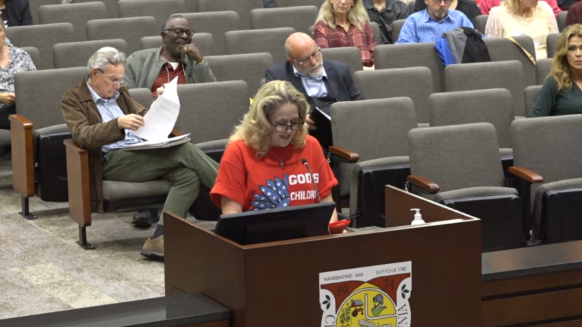Angela Kilgore (podium) addresses the Suffolk Public Schools Board during a meeting on November 9, 2023.