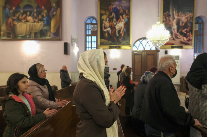 Iranian Christians attend the New Year mass at the Saint Targmanchats Armenian Church in Tehran on January 1, 2023. 