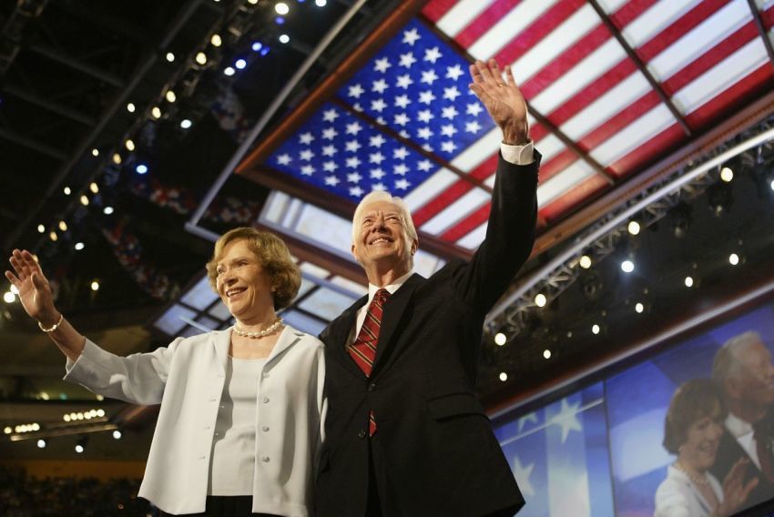 Former U.S. President Jimmy Carter and his wife, Rosalynn, wave to the audience during the Democratic National Convention at the Fleet Center July 26, 2004, in Boston, Massachusetts. 
