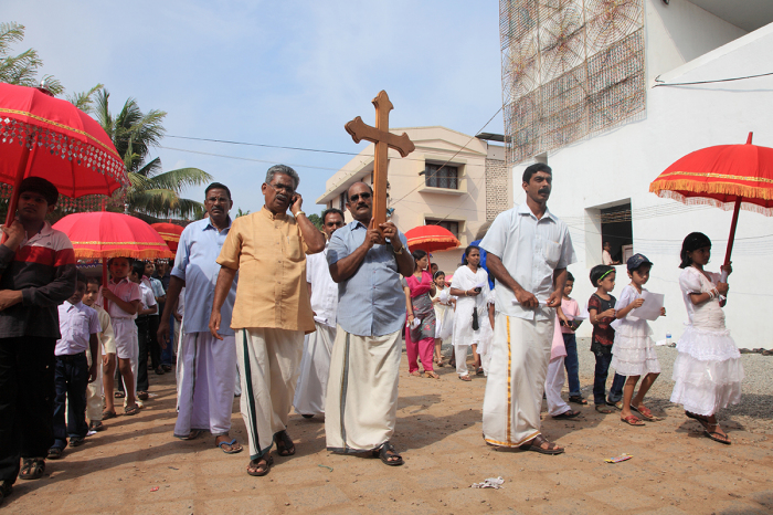 Unidentified devotees hold the holy cross on their head during the annual celebration of the Malankara Orthodox Church on November 2, 2010, in Parumala, Kerala, India.