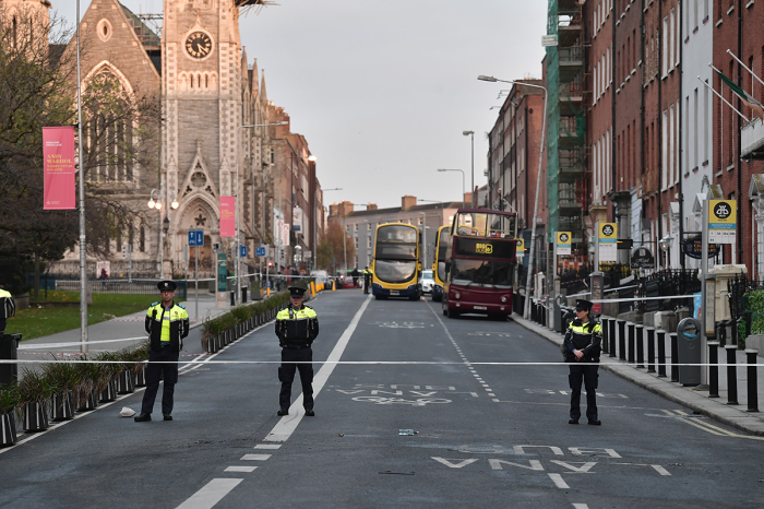 Three police officers stand near the crime scene of a stabbing on November 24, 2023, in Dublin, Ireland, that occurred the previous day. An Algerian man in his 50s stabbed five people, including three children. One child remains in critical condition. 